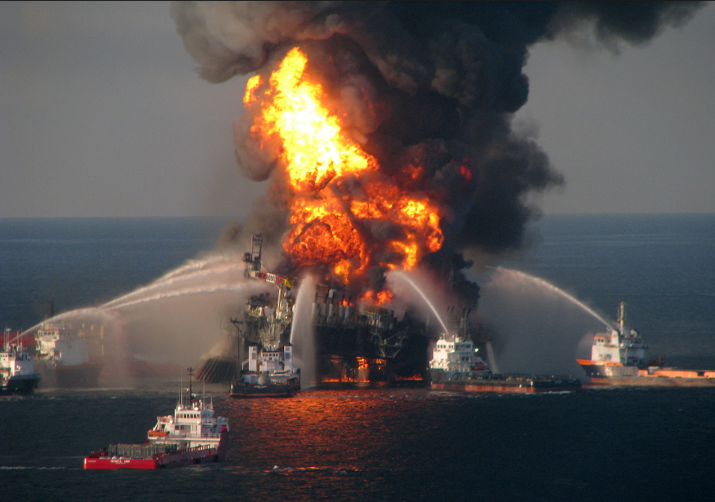 Several fire-rescue boats spray water on an oil rig that is on fire 